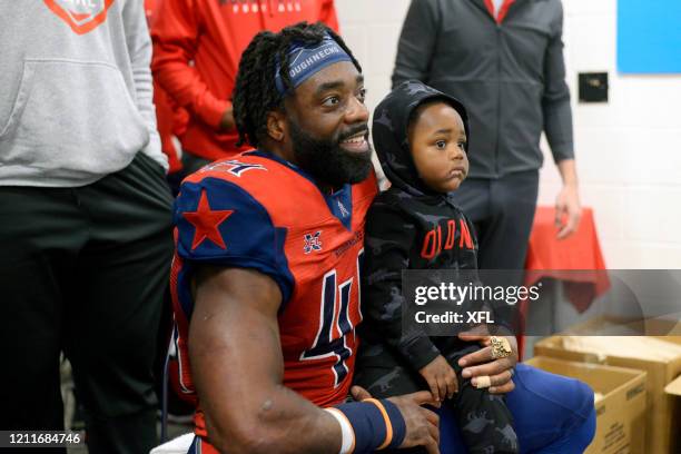 Andre Williams of the Houston Roughnecks brings his child into the locker room after the XFL game against the Seattle Dragons at TDECU Stadium on...