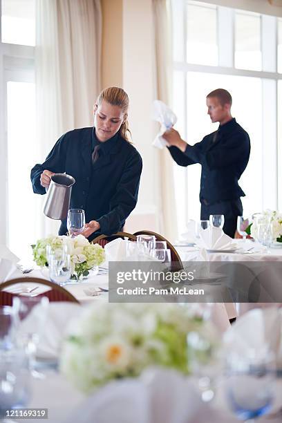 waiters setting banquet tables - wedding table setting stock-fotos und bilder