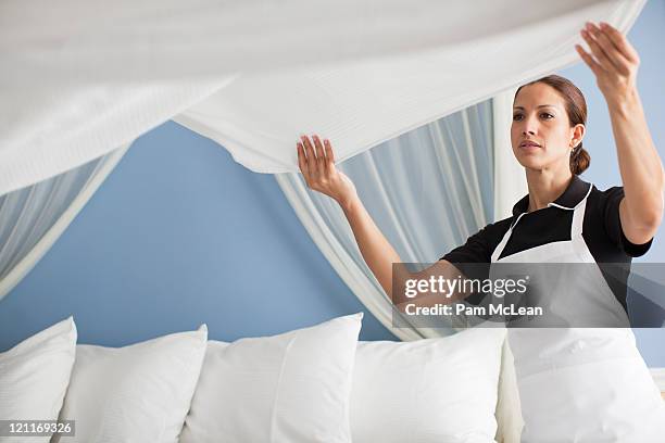 maid in hotel room making bed - hotel room work stock-fotos und bilder