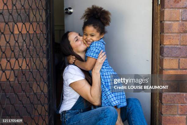 cuddles at home after school - parent daughter school uniform stock pictures, royalty-free photos & images