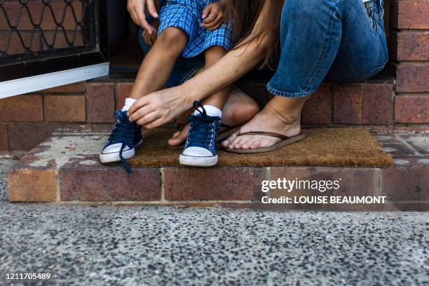 help with school shoes - tying shoelace stock pictures, royalty-free photos & images