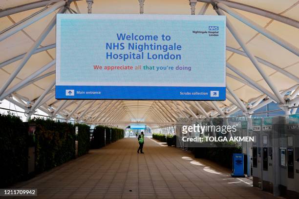 Security guard is seen outside the NHS Nightingale Hospital London on May 4, 2020 set up at the ExCel London exhibition and convention centre to help...