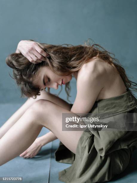 young depressed woman sitting on floor - anorexia nervosa stock pictures, royalty-free photos & images