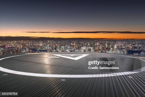 city tarmac against sunset - hélicoptère ville photos et images de collection