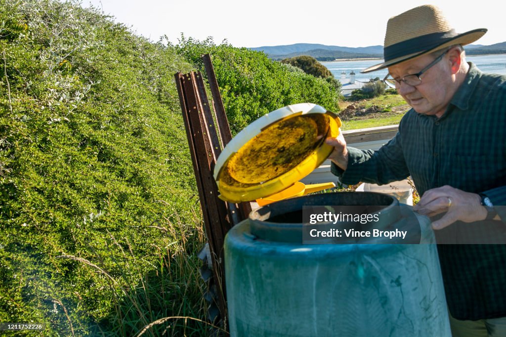 Senior man composting at home