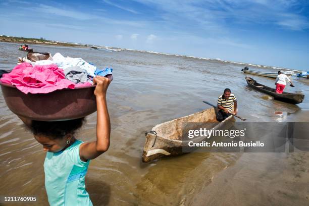 girl carrying laundry near a river - decompression sickness stock pictures, royalty-free photos & images