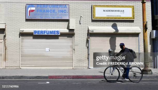 Closed shopfronts in what would be a normally busy fashion district in Los Angeles, California on May 4, 2020. - California governor Gavin Newsom...