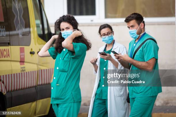 Health personnel wear face masks as a precaution against transmission of the covid-19 coronavirus outside the 12 de Octubre Hospital. The number of...
