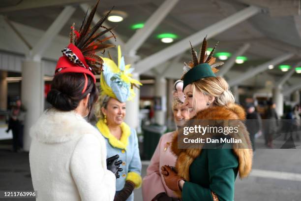 Race goers in decorative hats arrive for Ladies Day at Cheltenham Racecourse on March 11, 2020 in Cheltenham, England.