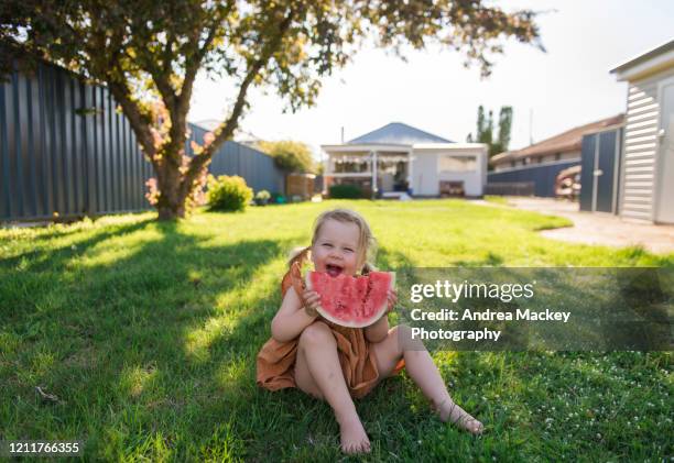 toddler girl eating watermelon - kids picnic stock pictures, royalty-free photos & images