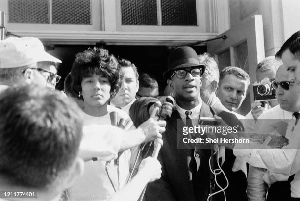African-American students Vivian Malone and James Hood are interviewed by reporters, as segregation in schools was broken by their entrance to the...