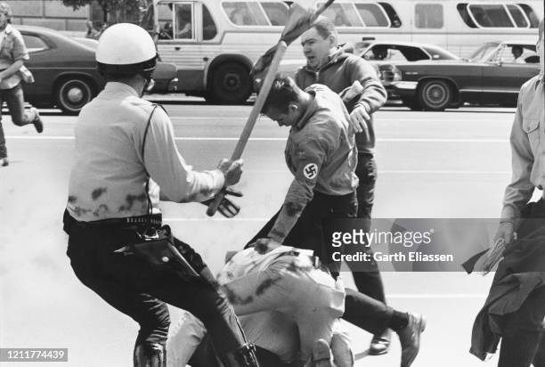 During a nationwide student strike , police officers clash with a neo-Nazi counter-protestor on Pennsylvania Avenue, Washington DC, US, 9th May 1970.