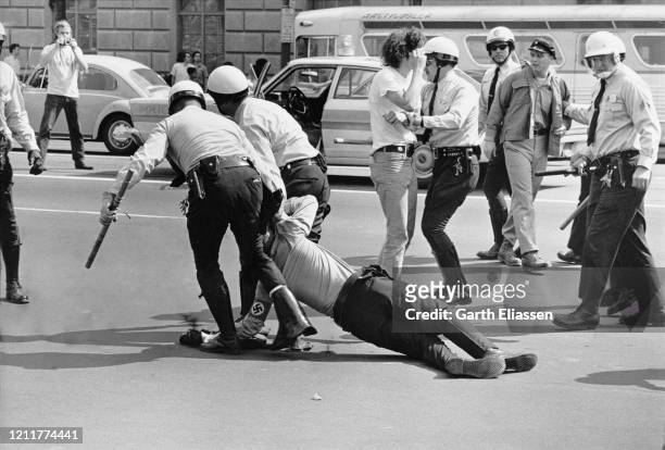 During a nationwide student strike , police officers arrest a neo-Nazi counter-protestor on Pennsylvania Avenue, Washington DC, US, 9th May 1970.