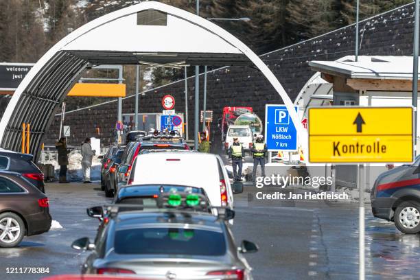 Austrian border police stop cars arriving from Italy for a health and temperature check at the Brenner Pass border crossing on March 11, 2020 near...