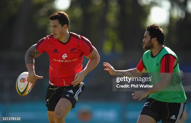 Sonny Bill Williams of the All Blacks offloads as Piri Weepu provides defence during the New Zealand All Blacks Training Session at Xerox Arena on...