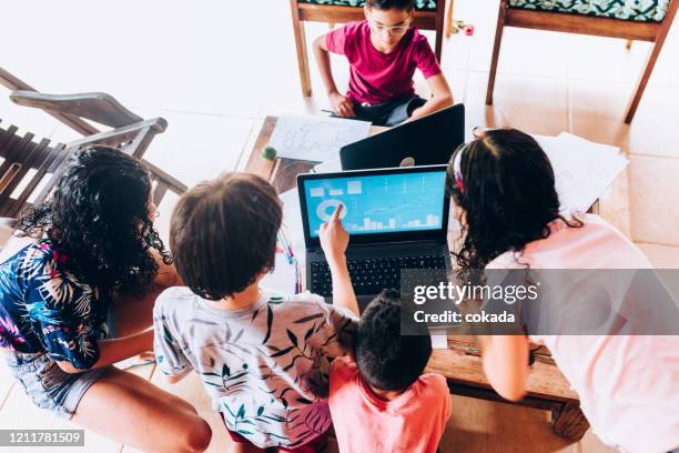 group of children analyzing sales graph on laptop - kid making money stock pictures, royalty-free photos & images