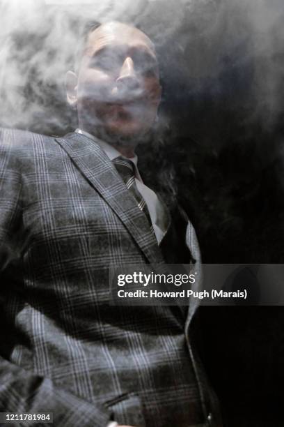 portrait of a gangster smoking an electronic cigarette - mafia stock pictures, royalty-free photos & images