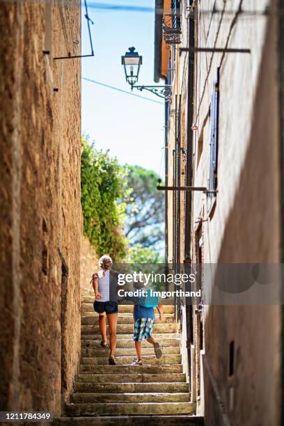 brother and sister running in italian town - child running up stairs stock pictures, royalty-free photos & images