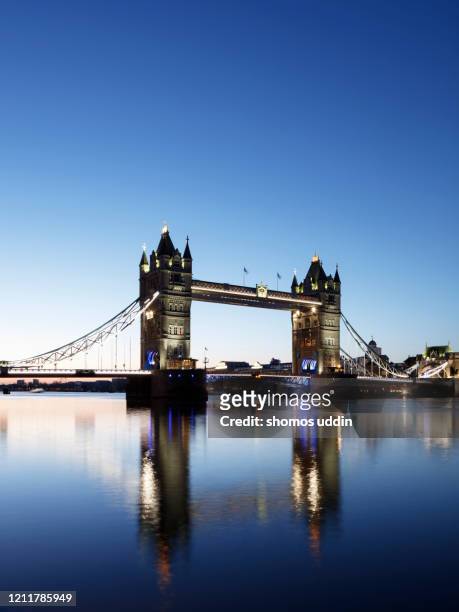 london tower bridge illuminated at dawn - london dawn stock pictures, royalty-free photos & images
