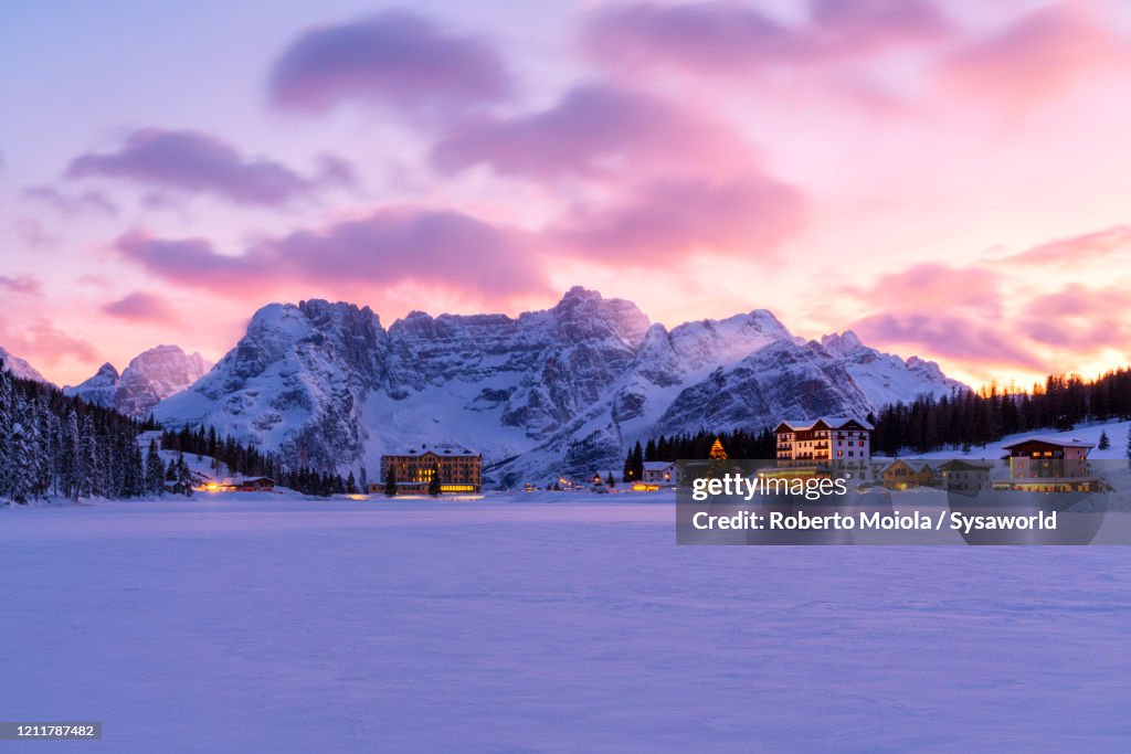 Pink sky at sunset on Misurina and Sorapis covered with snow, Dolomites, Veneto, Italy