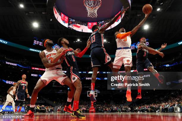 Barrett of the New York Knicks shoots in front of Thomas Bryant and Bradley Beal of the Washington Wizards during the second half at Capital One...