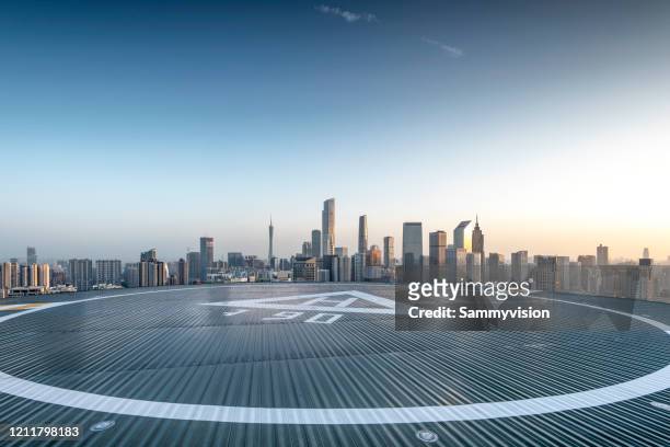 urban road against city skyline - helipad stock pictures, royalty-free photos & images