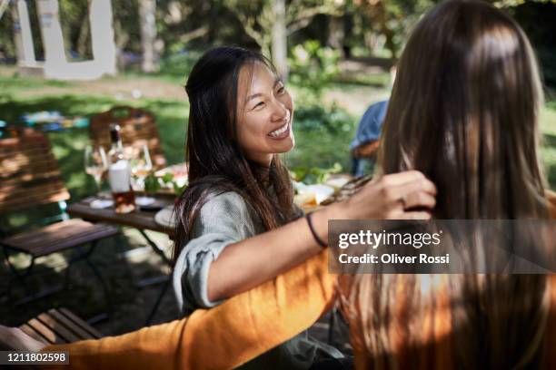two happy young women a garden party - al fresco dining stock pictures, royalty-free photos & images