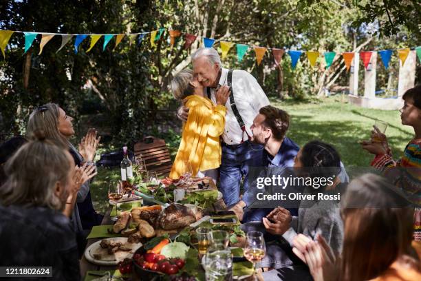 happy senior couple hosting a garden party - aniversário-de-casamento imagens e fotografias de stock
