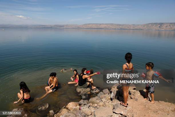 Person swims in the Sea of Galilee known in Hebrew as the Kinneret in northern Israel on May 4, 2020 amid the coronavirus Covid-19 pandemic. - Sea of...