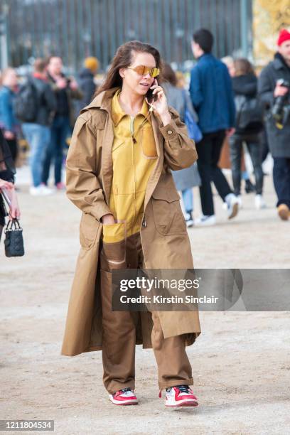 Fashion consultant and Stylist Charlotte Stockdale wears Nike trainers, Mulberry coat, Fendi boiler suit and sunglasses on February 25, 2020 in...