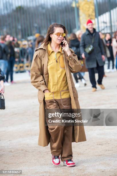 Fashion consultant and Stylist Charlotte Stockdale wears Nike trainers, Mulberry coat, Fendi boiler suit and sunglasses on February 25, 2020 in...