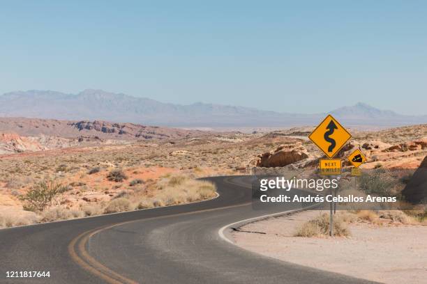 curve road crossing the desert - nevada stock pictures, royalty-free photos & images