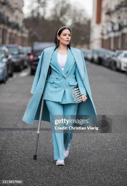 Beau Dunn is seen wearing turquoise coat, blazer and pants, see through bag on March 04, 2020 in London, England.
