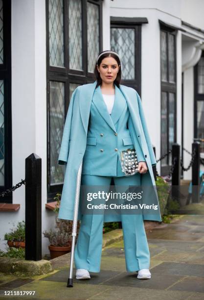 Beau Dunn is seen wearing turquoise coat, blazer and pants, see through bag on March 04, 2020 in London, England.