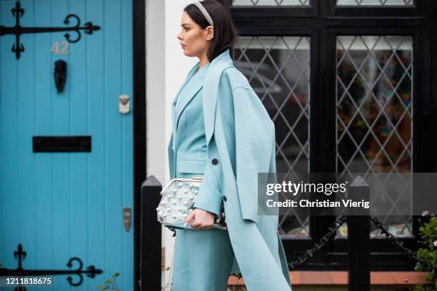 Beau Dunn is seen wearing turquoise coat, blazer and pants, see through bag on March 04, 2020 in London, England.