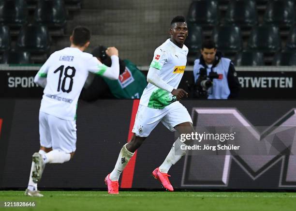 Breel Embolo of Borussia Monchengladbach celebrates after scoring his team's first goal with Stefan Lainer during the Bundesliga match between...