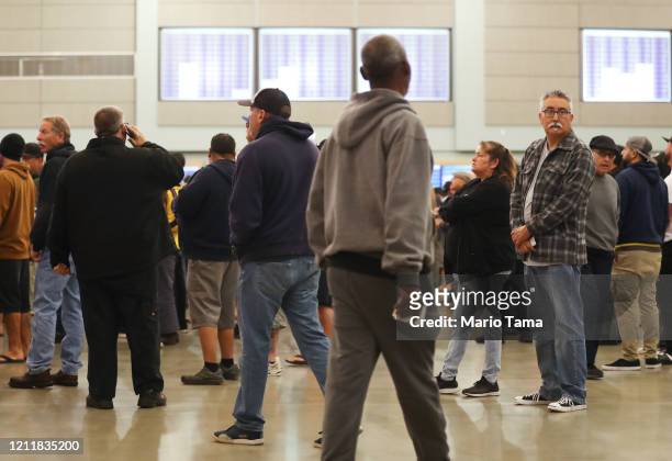 International Longshore and Warehouse Union Local 13 workers await daily job opportunities for Los Angeles and Long Beach ports at the ILWU dispatch...