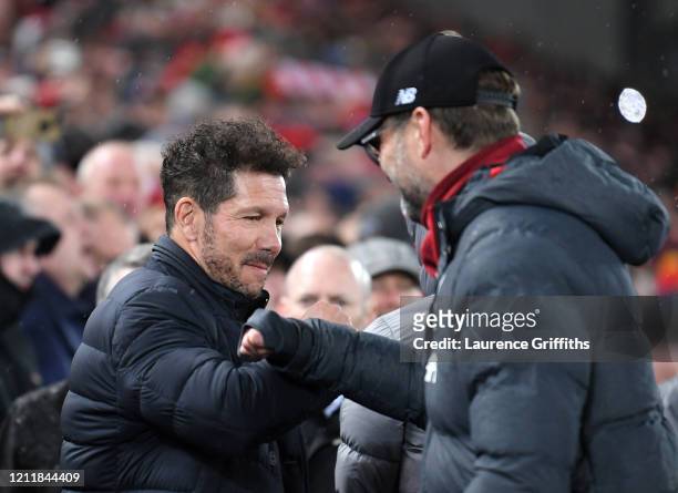Diego Simeone, Manager of Atletico Madrid and Jurgen Klopp, Manager of Liverpool bump elbows prior to the UEFA Champions League round of 16 second...
