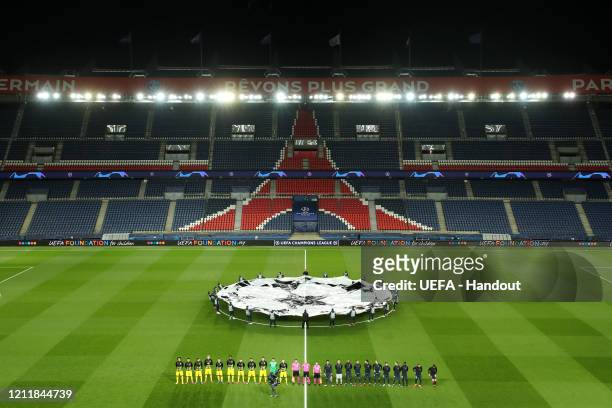 In this handout image provided by UEFA, General view inside the empty stadium as the two teams line up prior to the UEFA Champions League round of 16...
