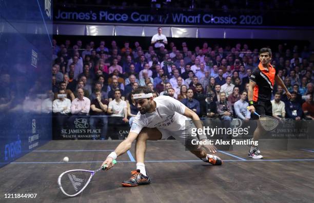 Mohamed El Shorbagy of Egypt plays a shot against Saurav Ghosal of India during the Quarter Final match of The Canary Wharf Squash Classic between...