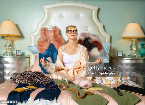 fashion stylist contemplating her wardrobe - grace chan stock pictures, royalty-free photos & images