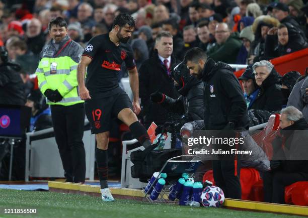 Diego Costa of Atletico Madrid kicks a bunch of water bottles as he reacts to being subbed during the UEFA Champions League round of 16 second leg...