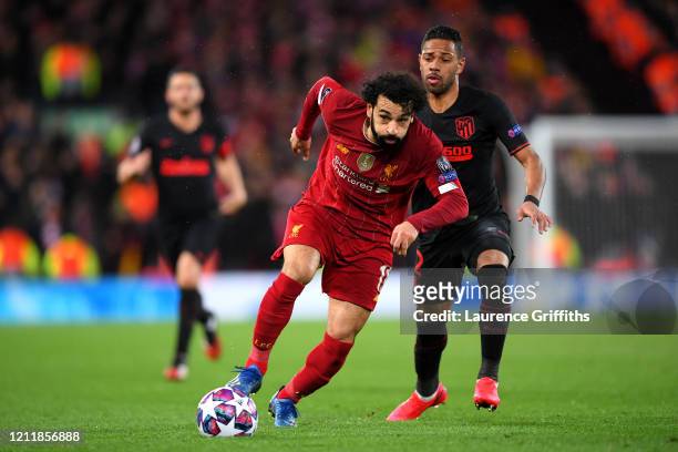 Mohamed Salah of Liverpool gets away from Renan Lodi of Atletico Madrid during the UEFA Champions League round of 16 second leg match between...