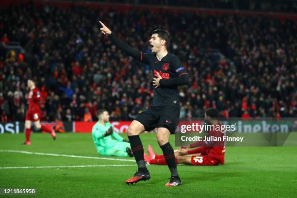 Alvaro Morata of Atletico Madrid celebrates after scoring his team's third goal as Adrian and Joe Gomez of Liverpool react during the UEFA Champions...