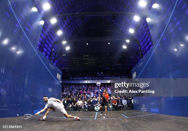 Mohamed El Shorbagy of Egypt plays a shot against Saurav Ghosal of India during the Quarter Final match of The Canary Wharf Squash Classic between...