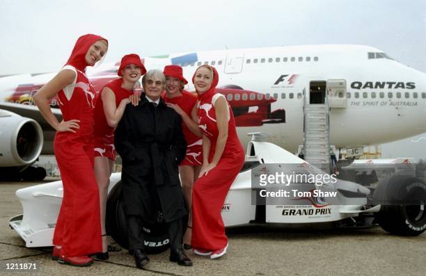 Senate member Bernie Ecclestone with the Qantas Grid Girls at the Qantas Australian Grand Prix briefing and photocall at Heathrow Airport in London....