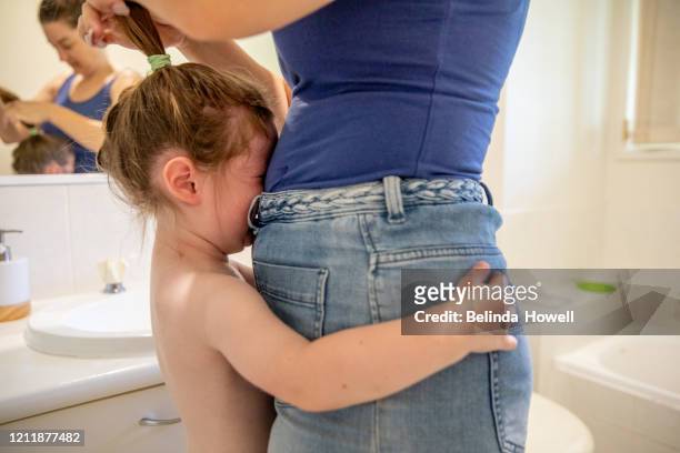 australian mother of two young children in her family home participating in domestic life activities - woman and toddler stock pictures, royalty-free photos & images