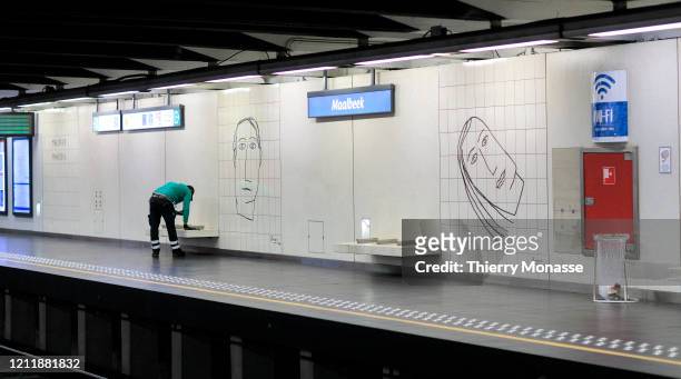 Worker cleans the Maelbeek metro station on the Brussels underground train system on May 5, 2020 in Brussels, Belgium. On Monday May 4, 242 new cases...