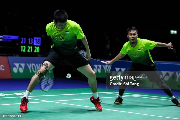 Hendra Setiawan and Mohammad Ahsan of Indonesia compete in the Men's Doubles first round match against Akira Koga and Taichi Saito of Japan on day...