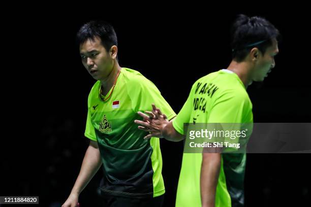 Hendra Setiawan and Mohammad Ahsan of Indonesia react in the Men's Doubles first round match against Akira Koga and Taichi Saito of Japan on day one...